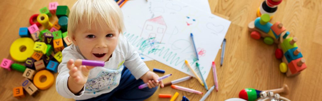 A kid is drawing and learning some new activities - Wimbledon Day Nursery