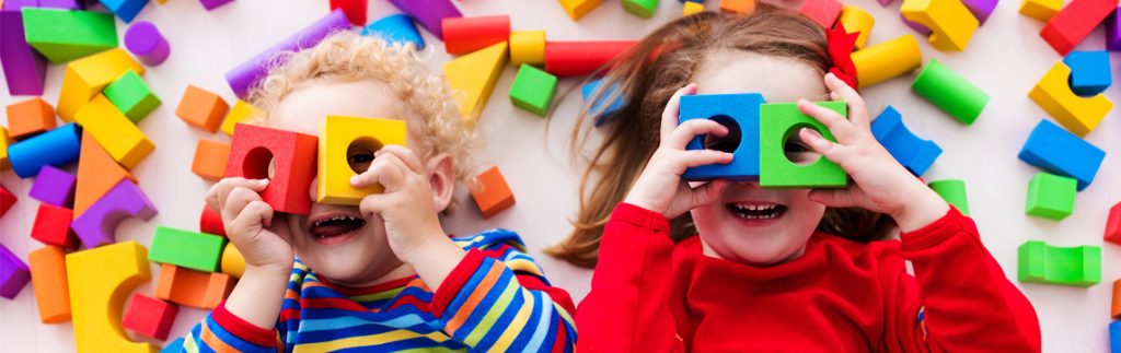 Two kids are very happy exploring some new things - Wimbledon Day Nursery